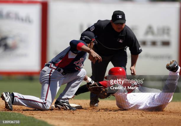 Cincinnati catcher David Ross is tagged out by Atlanta's Tony Pena on this play during Sunday's action at Ed Smith Stadium in Sarasota, Florida on...