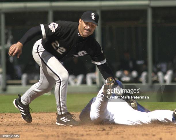 Kansas City Royals outfielder David DeJesus slides underneath the tag of Chicago White Sox shortstop Jose Valentin in the sixth inning of a game at...
