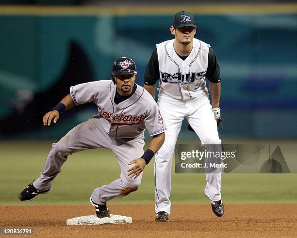 Cleveland Indians outfielder Coco Crisp slides safely into second as Tampa's Jorge Cantu looks on in Monday night's game at Tropicana Field in St....