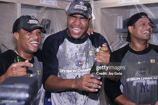 New York Yankees Robison Cano, Jose Veras, and Bobby Abreu celebrate in the clubhouse after clinching their 9th consecutive American League East...