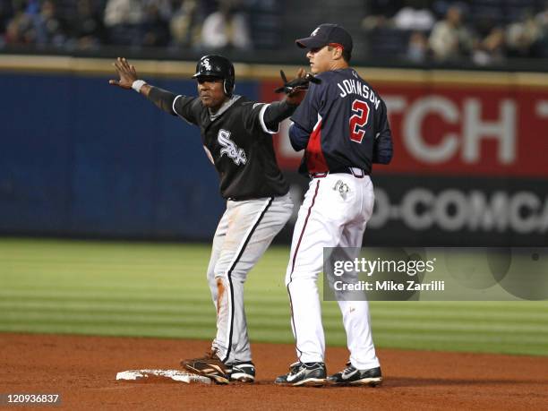 Chicago's Pablo Ozuna helps the umpire make a call after he beat Atlanta second baseman Kelly Johnson to the base on a fielder's choice during the...