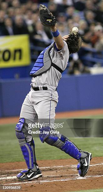 Kansas City Royals C John Buck dropped this foul pop off the bat of Vernon Wells in MLB action vs the Toronto Blue Jays at Rogers Centre in Toronto,...