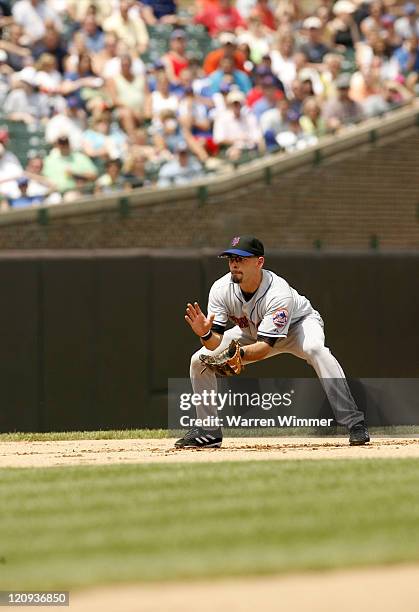 Chris Woodward, shortstop of the New York Mets, makes a play on Juan Pierre of the Chicago Cubs during game action at Wrigley Field, Chicago,...