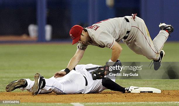 Los Angeles Angels of Anaheim 2nd baseman Adam Kennedy dives over Toronto's Eric Hinske after an attempted pick off in MLB action vs the Toronto Blue...