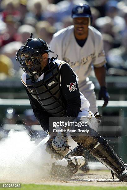 Pittsburgh Pirates catcher Benito Santiago digs for the ball during action against the Milwaukee Brewers at PNC Park on April 4, 2005 in Pittsburgh,...