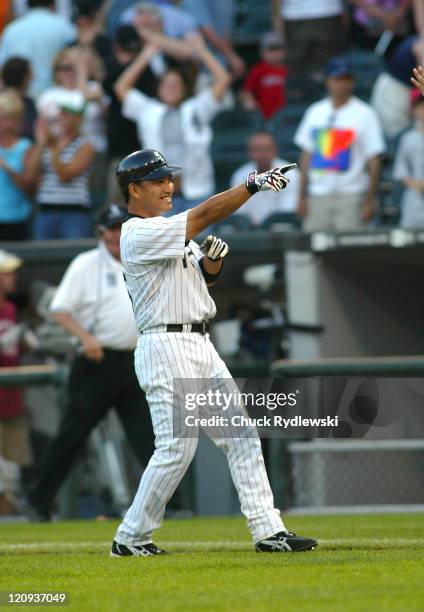 Chicago White Sox' 2nd Baseman, Tadahito Iguchi, points to teammates after singling in the winning run against the Boston Red Sox July 9, 2006 at...