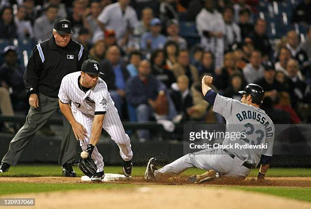 Seattle Mariners' DH, Ben Broussard, slides safely into 3rd base as the throw from the outfield eludes Josh Fields during their game against the...