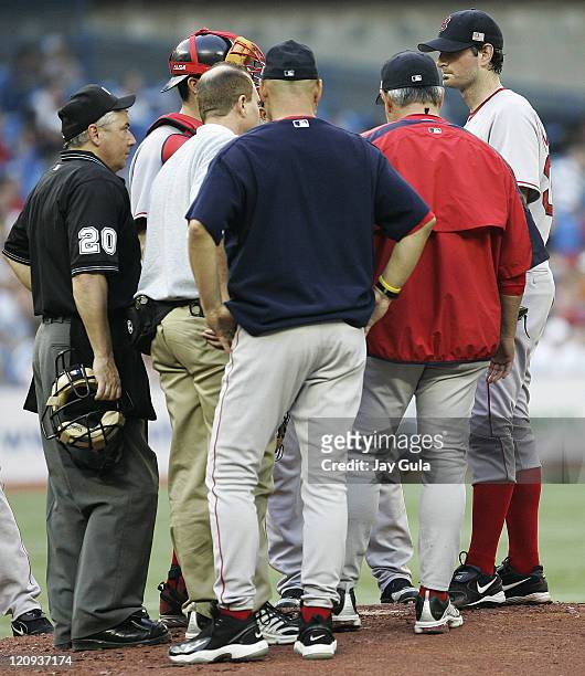 Boston Red Sox P Matt Clement consults with Manager Terry Francona and other personnel regarding an undisclosed ailment during tonight's game vs the...