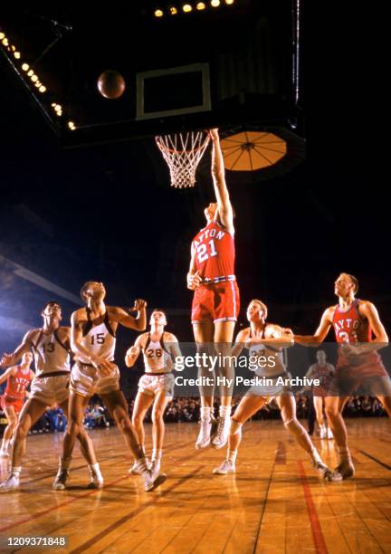 Bill Uhl of the Dayton Flyers goes for the rebound during an NCAA game against the Iona Gaels on January 7, 1956 at Madison Square Garden in New...