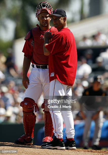 Boston manager Terry Francona makes a pitching change as catcher Josh Bard looks on during Saturday's game at City of Palms Park in Ft. Myers,...