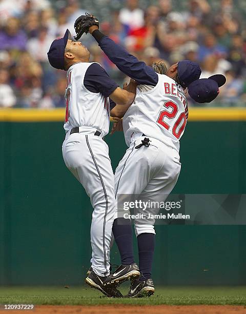 Cleveland Indians' Alex Cora, left and Ronnie Belliard collide after going for a ball hit by Minnesota Twins' Shannon Stewart in the fourth inning...
