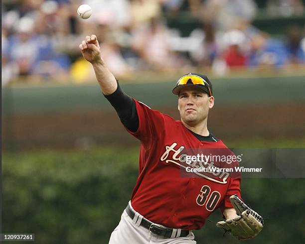 Houston Astro left fielder, Luke Scott, throwing during game action at Wrigley Field, Chicago, Illinois, USA. July 20 the Chicago Cubs, led by...