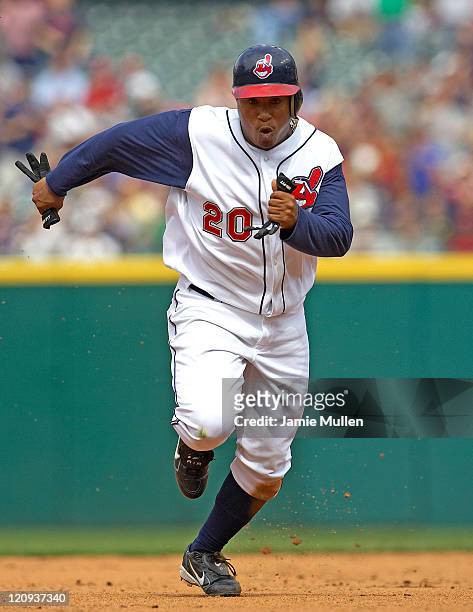 Cleveland Indians' Ronnie Belliard heads to third base after a throwing error by Minnesota third baseman Michael Cuddyer during the game Sunday,...