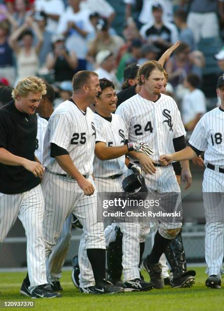 Chicago White Sox' 2nd Baseman, Tadahito Iguchi, is greeted by teammates after singling in the winning run against the Boston Red Sox July 9, 2006 at...