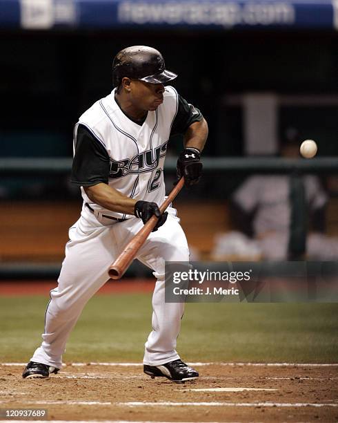 Tampa Bay's Damon Hollins tries to bunt his way on in Wednesday night's game against the New York Yankees at Tropicana Field in St. Petersburg,...