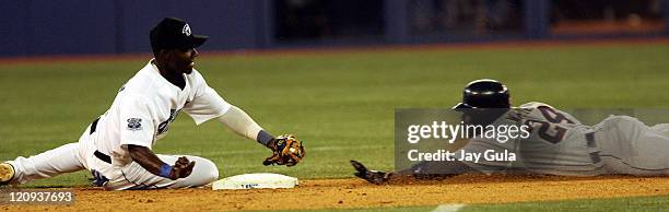 Detroit's Rondell White was safe at 2nd with a double despite the efforts of Toronto's Orlando Hudson in MLB action at the Rogers Centre in Toronto,...