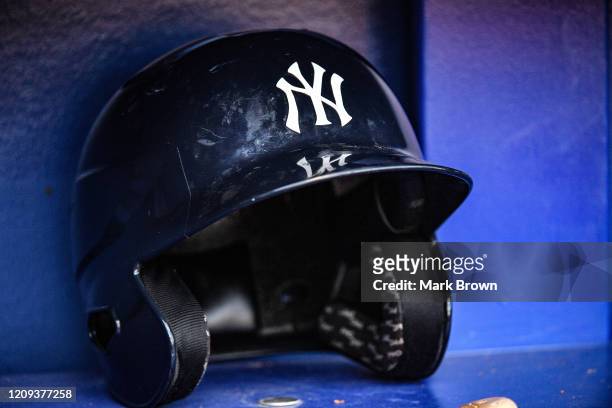 Detailed view of the New York Yankees batting helmet resting in the dugout during the spring training game against the Atlanta Braves at Cool Today...