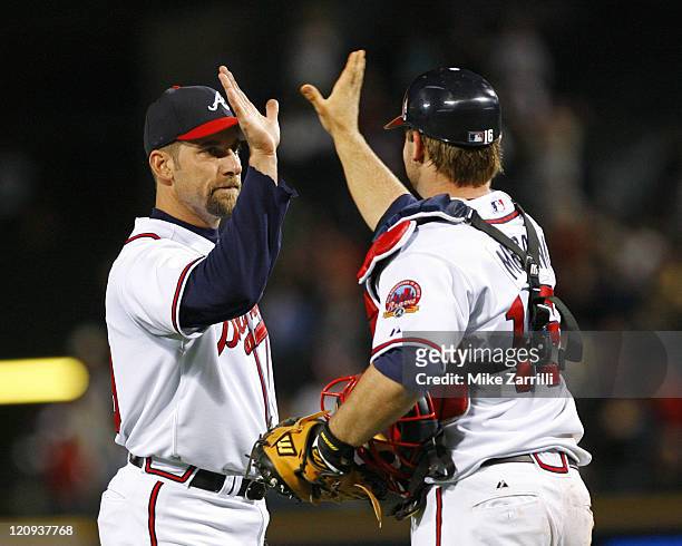 Atlanta Braves pitcher John Smoltz is congratulated by catcher Brian McCann after Smoltz's complete game win against the Washington Nationals at...