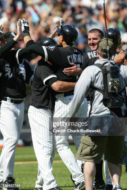 Chicago White Sox' second baseman, Alex Cintron, is mobbed at home plate after singling in the winning run against the Houston Astros June 24, 2006...