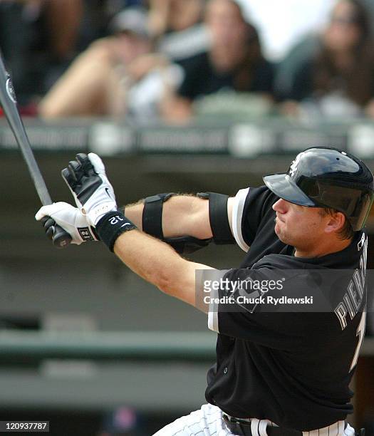 Chicago White Sox' catcher, A.J. Pierzynski, follows through on his two-run homer in the 5th inning during their game against the Minnesota Twins...