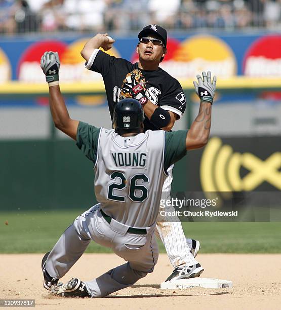 Chicago White Sox 2nd Baseman, Tadahito Iguchi turns a double play as Delmon Young bears down on him during their game versus the Tampa Bay Devil...