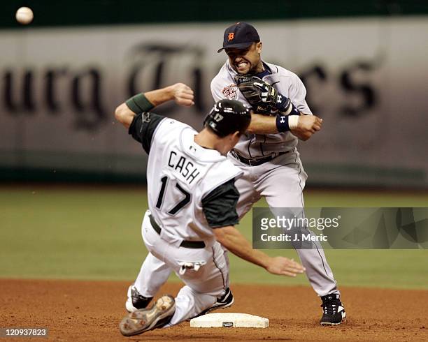 Tampa Bay's Kevin Cash tries to break up a double play as Detroit's Placido Polanco makes the throw to first in Sunday's game at Tropicana Field in...