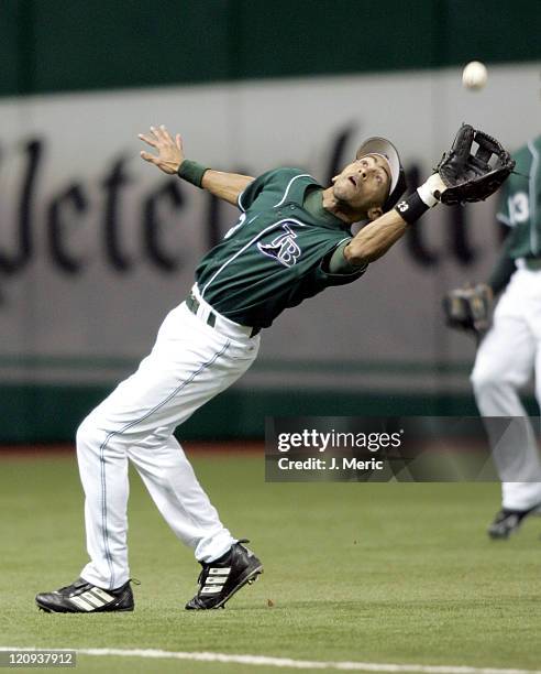 Tampa Bay Devil Rays shortstop Julio Lugo almost overruns a fly ball in Thursday night's game against the Detroit Tigers at Tropicana Field in St....