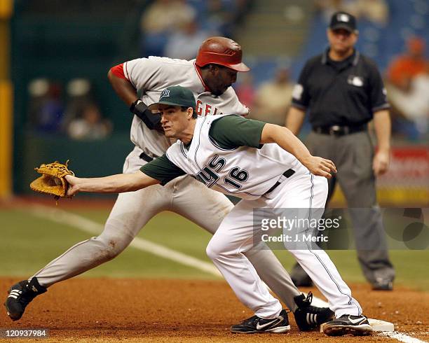 Tampa Bay's Travis Lee makes the grab at first as Angel's outfielder Vladimir Guerrero makes it back safely during Wednesday's action at Tropicana...
