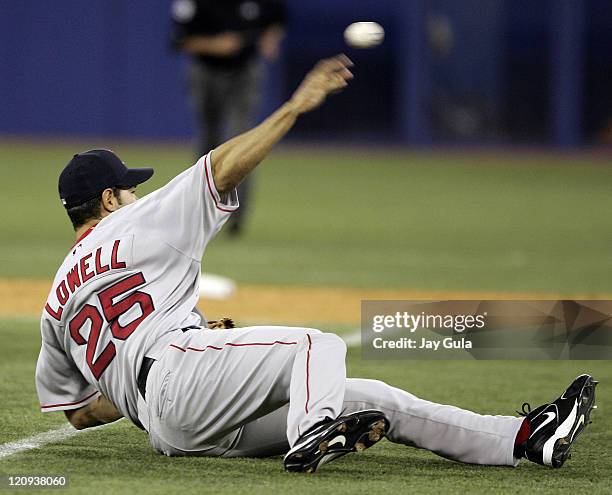 Boston 3B Mike Lowell made a diving stop and threw from a prone position to just nail Toronto's Aaron Hill at 1st base in MLB action at Rogers Centre...