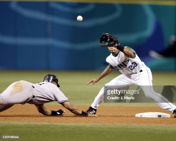 Tampa Bay Devil Rays shortstop prepares to take the throw as New York Yankee outfielder Gary Sheffield slides in safely at second on a pickoff play...