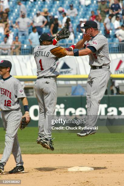 Minnesota Twins' Right Fielder, Michael Cuddyer, and 2nd Baseman, Luis Castillo, celebrate after the game against the Chicago White Sox July 26, 2006...