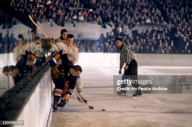 Lou Fontinato of the New York Rangers goes for the puck as he is defended by Claude Provost of the Montreal Canadiens during their game on October...