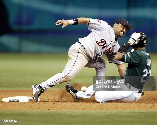 Tampa Bay's Julio Lugo slides in safely with a steal as Detroit's Placido Polanco tries to get the throw in Thursday night's game at Tropicana Field...