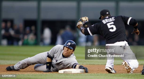 New York Yankees' Left Fielder, Hideki Matsui evades Juan Uribe's tag and slides safely into 2nd base during their game versus the Chicago White Sox...