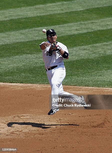 Chicago White Sox' 2nd Baseman, Tadahito Iguchi makes a leaping throw to get the batter at first base during their game versus the New York Yankees...