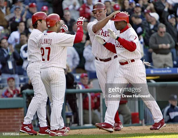 Philadelphia's David Bell, Placido Polanco and Jim Thome congratulate Phillies center fielder Kenny Lofton after he hit a 3 run home-run in the fifth...