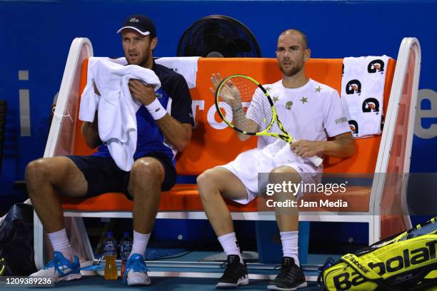 Adrian Mannarino and Fabrice Martin of France look on during the singles match between Robert Farah and Sebastian Cabal of Colombia and Adrian...