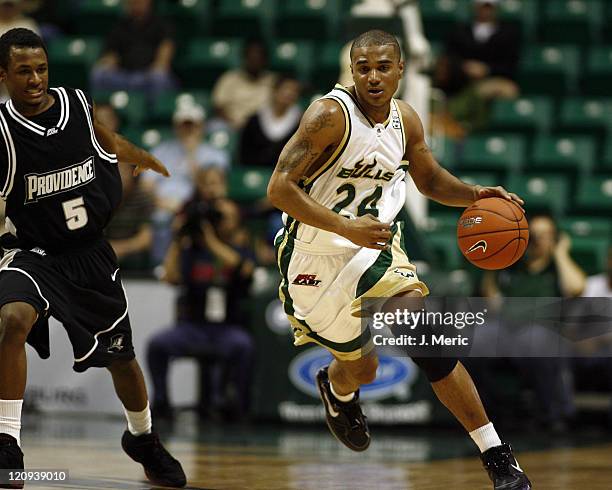 South Florida's Chris Howard looks to drive the ball around Providence College's Dwain Williams during Wednesday night's game at the Sundome in...