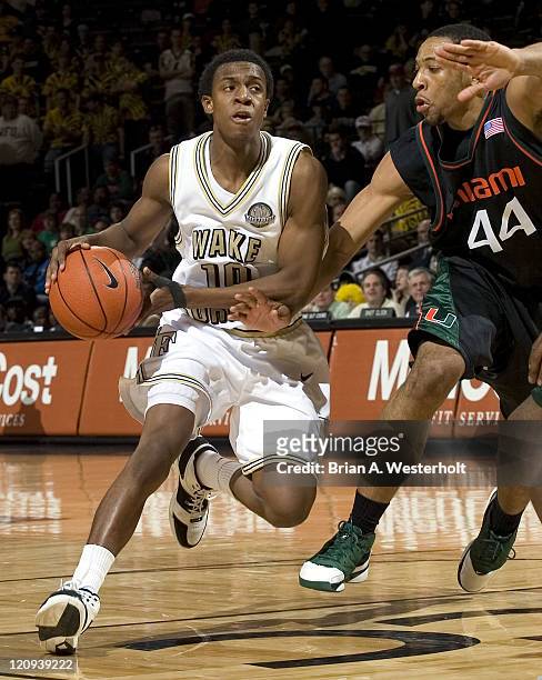 Wake Forest's Ishmael Smith tries to dribble around Miami's Keaton Copeland during second half action at the Lawrence Joel Veterans Memorial Coliseum...