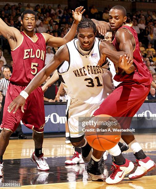 Wake Forest center Eric Williams battles Elon forward Gary Marsh for a loose ball in the first half of the Demon Deacons 97-55 victory over the...