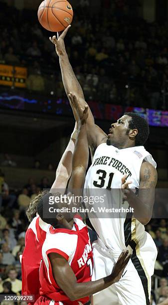 Wake Forest center Eric Williams shoots over Richmond forward Jamaal Scott for 2 of his 21 points as the Demon Deacons defeated the Spiders by a...