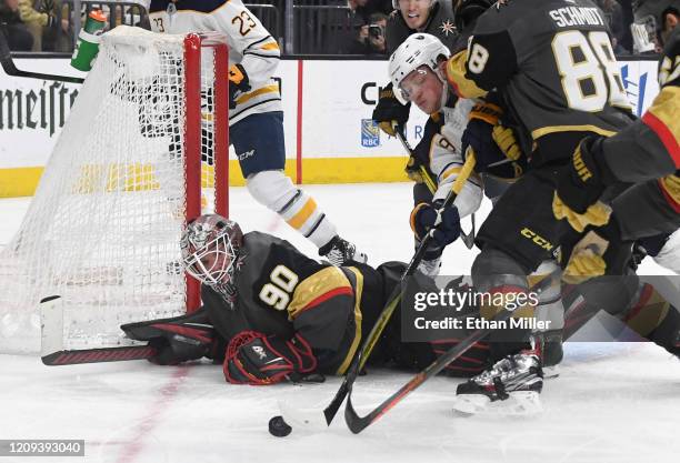 Robin Lehner of the Vegas Golden Knights defends the net against Jack Eichel of the Buffalo Sabres after Lehner made a diving save in the third...