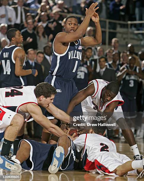 Penn Quakers Mark Zoller , Ibrahim Jaaber and David Whitehurst fight for the ball with Villanova guard Randy Foye while Kyle Lowry tries to call a...