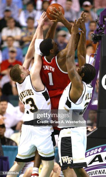 Jamar Smith is surrounded by Vytas Danelius and Eric Williams during first half action, March 12, 2004.