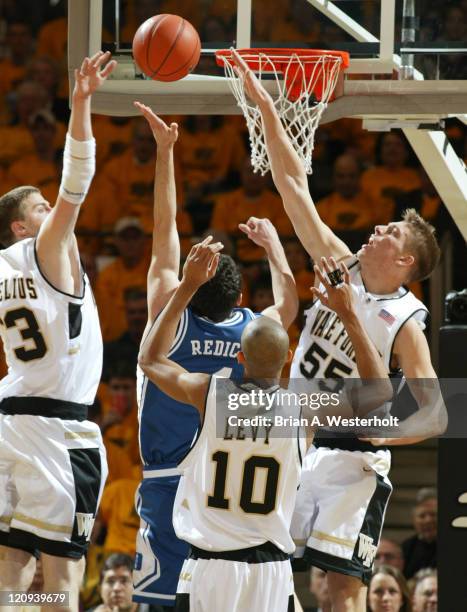 Duke's J.J. Redick is surrounded by Vytas Danelius , Jamaal Levy and Kyle Visser during first half action, February 18, 2004.