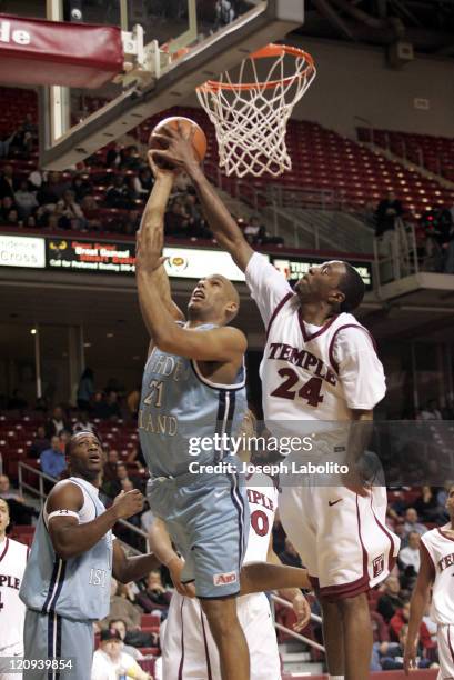 Temple's Antywane Robinson contests a shot by URI's Scott Hazelton as Temple defeated Rhode Island 74 to 54 at the Liacouras Ctr in Philadelphia on...
