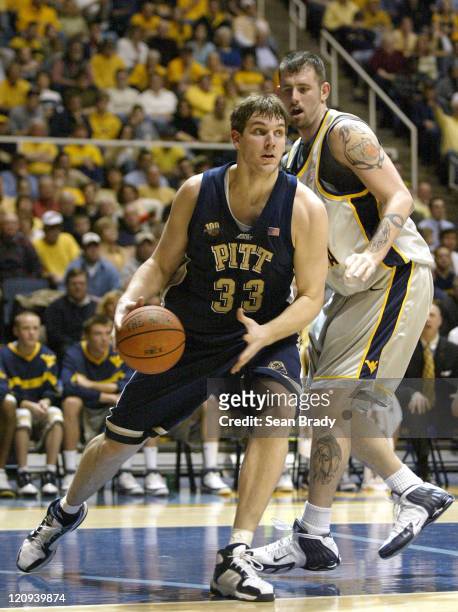 Pittsburgh's Aaron Gray drives on West Virginia's Kevin Pittsnogle during action at the WVU Coliseum in Morgantown, West Virginia on February 27,...