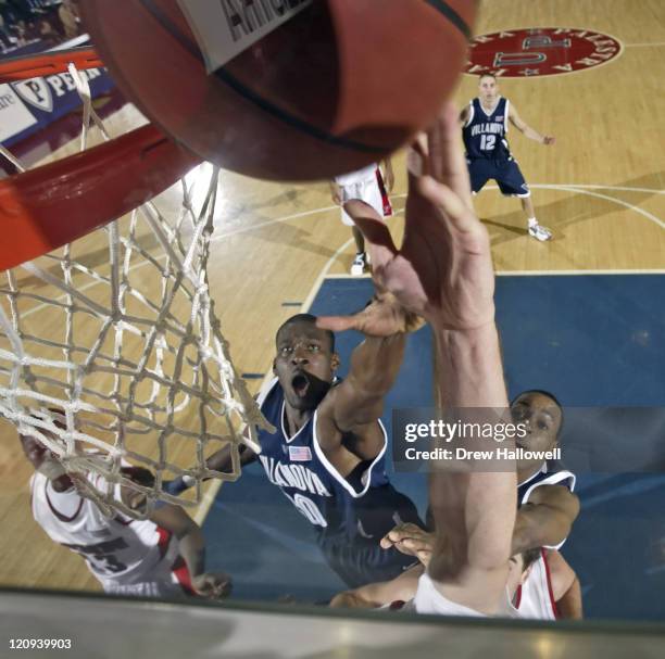 Villanova forward Jason Fraser and Randy Foye go up for a rebound with an unidentified Penn player Tuesday, December 13, 2005 at The Palestra in...