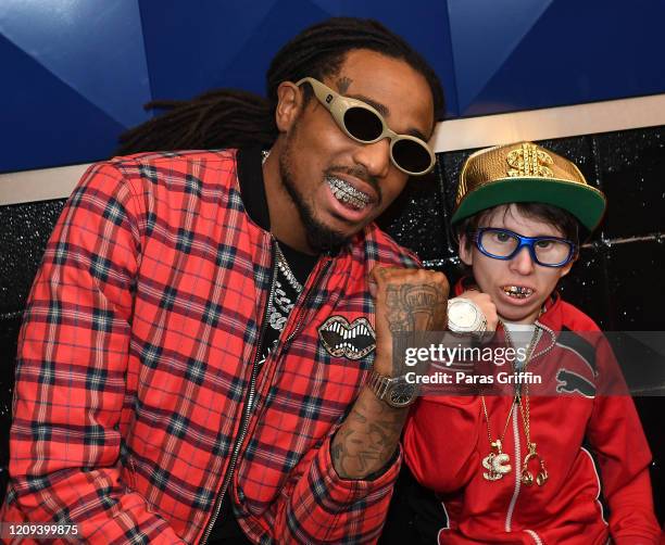 Quavo of Migos poses with fan Charlie Wilgus during Brooklyn Nets vs Atlanta Hawks game at State Farm Arena on February 28, 2020 in Atlanta, Georgia.