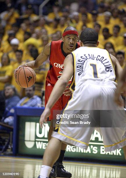 Cincinnati's James White prepares to drive on West Virginia's J.D. Collins during action at the WVU Coliseum on February 4, 2006 in Morgantown, West...